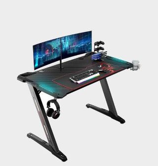Eureka Z1S gaming desk with dual monitors on top and grey backdrop