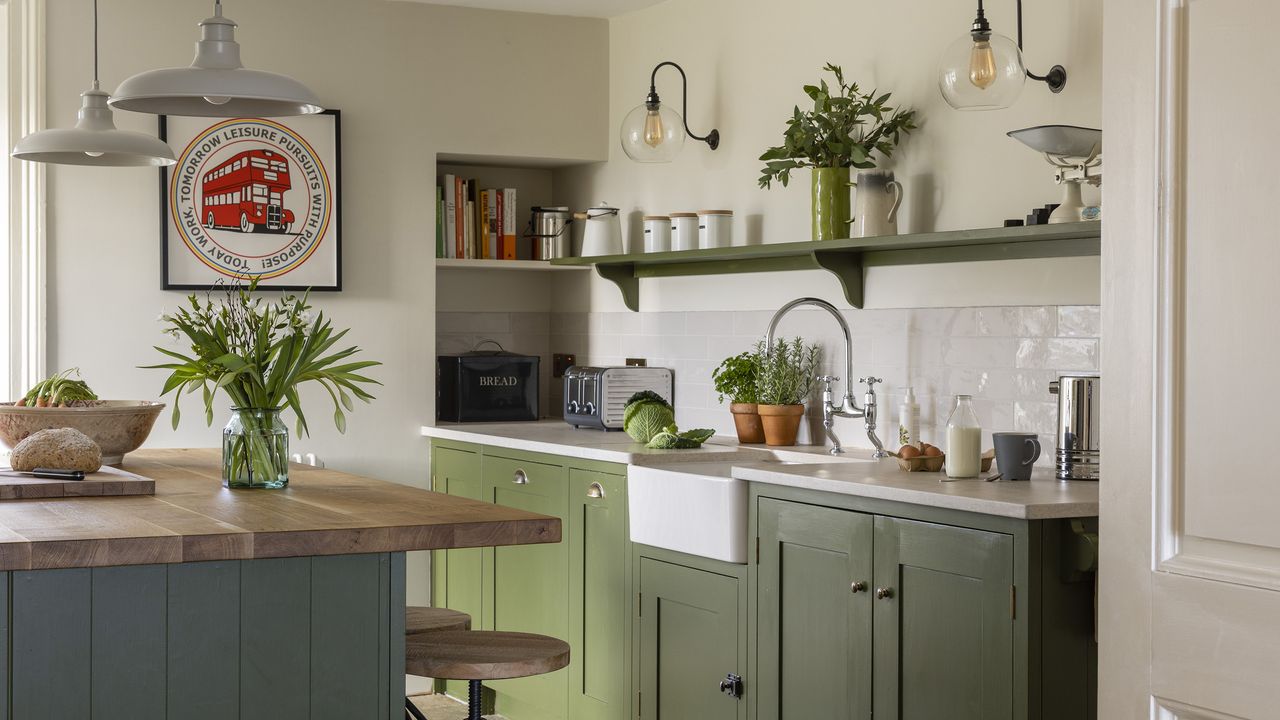 Green shaker kitchen with island and open shelving.