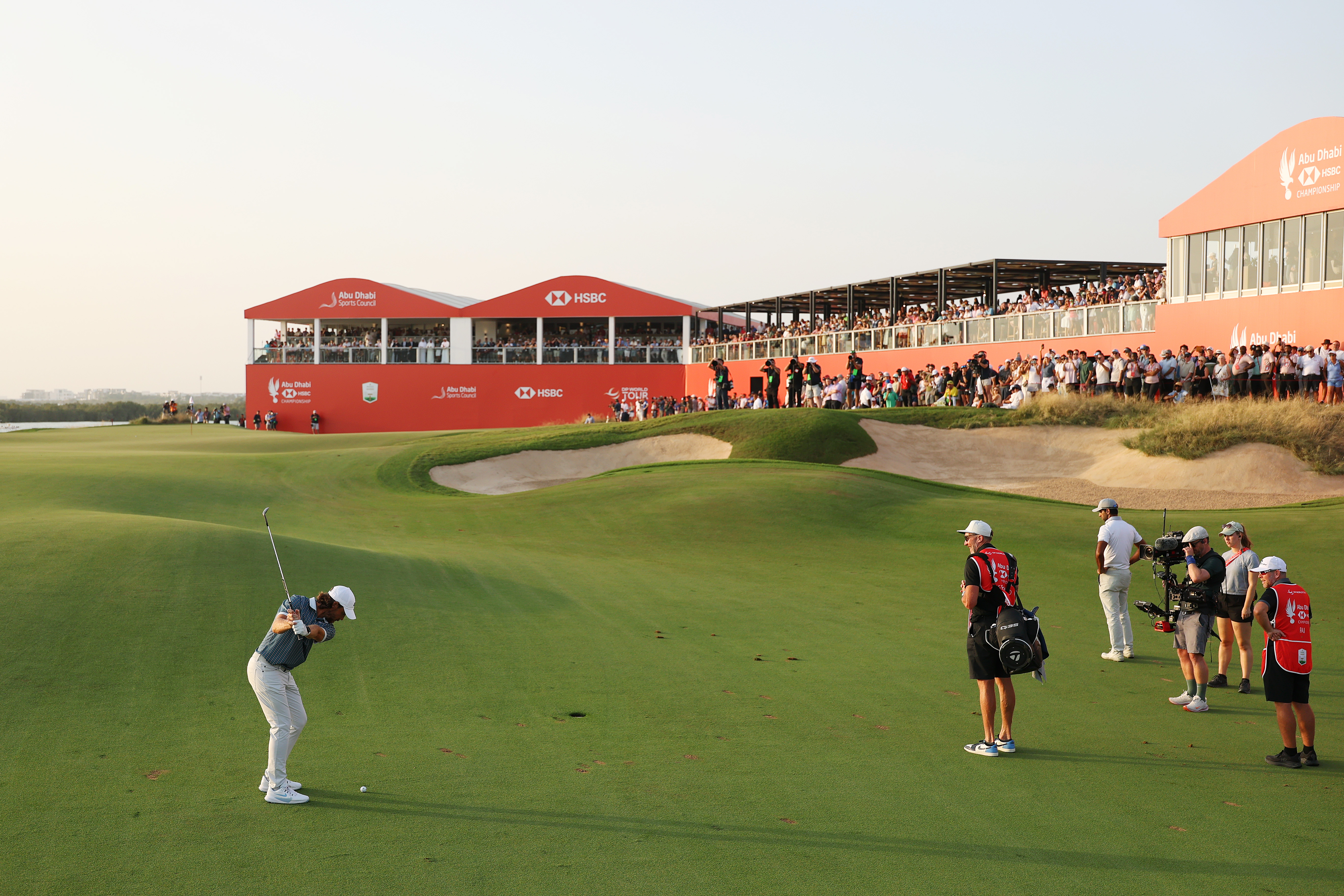 Tommy Fleetwood hits a wedge into the 18th hole at the 2025 Abu Dhabi HSBC Championship