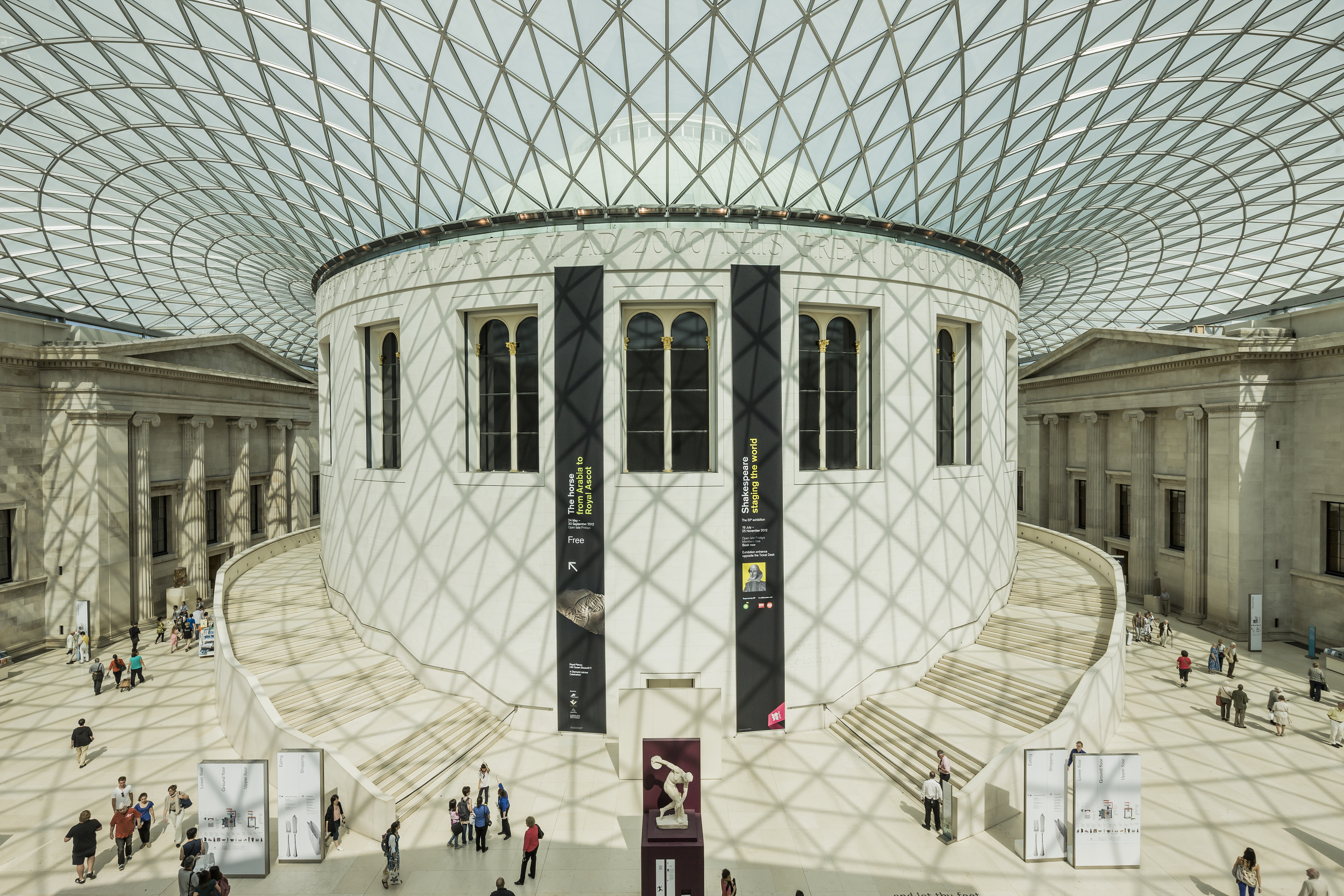 Atrium of the British Museum with light pouring in through the glass ceiling creating patterns on the floor