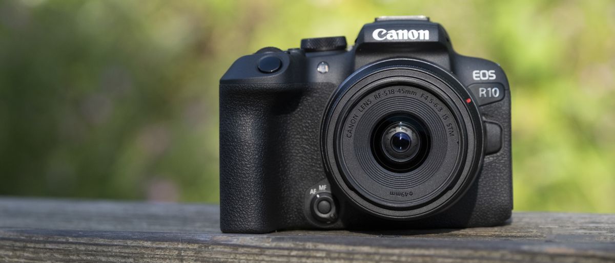 The Canon EOS R10 camera sitting on a wooden bench