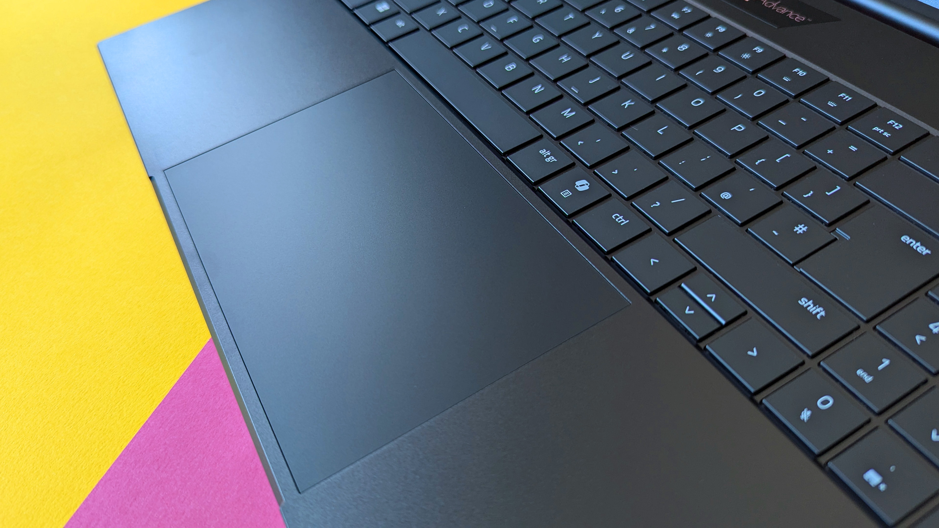 Razer Blade 18 (2025) gaming laptop on a pink and yellow background.