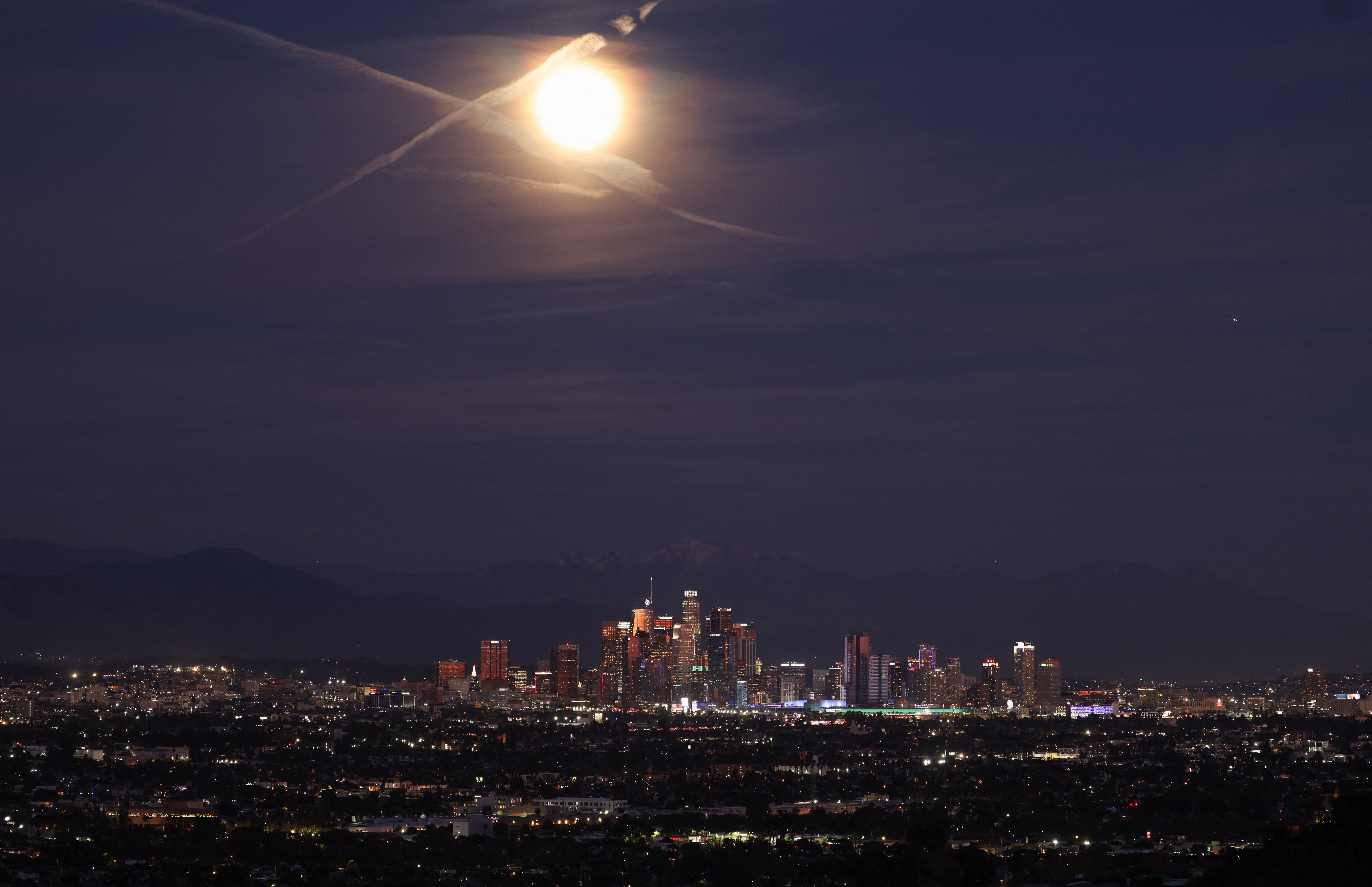 A photo of a bright full moon above Los Angeles.