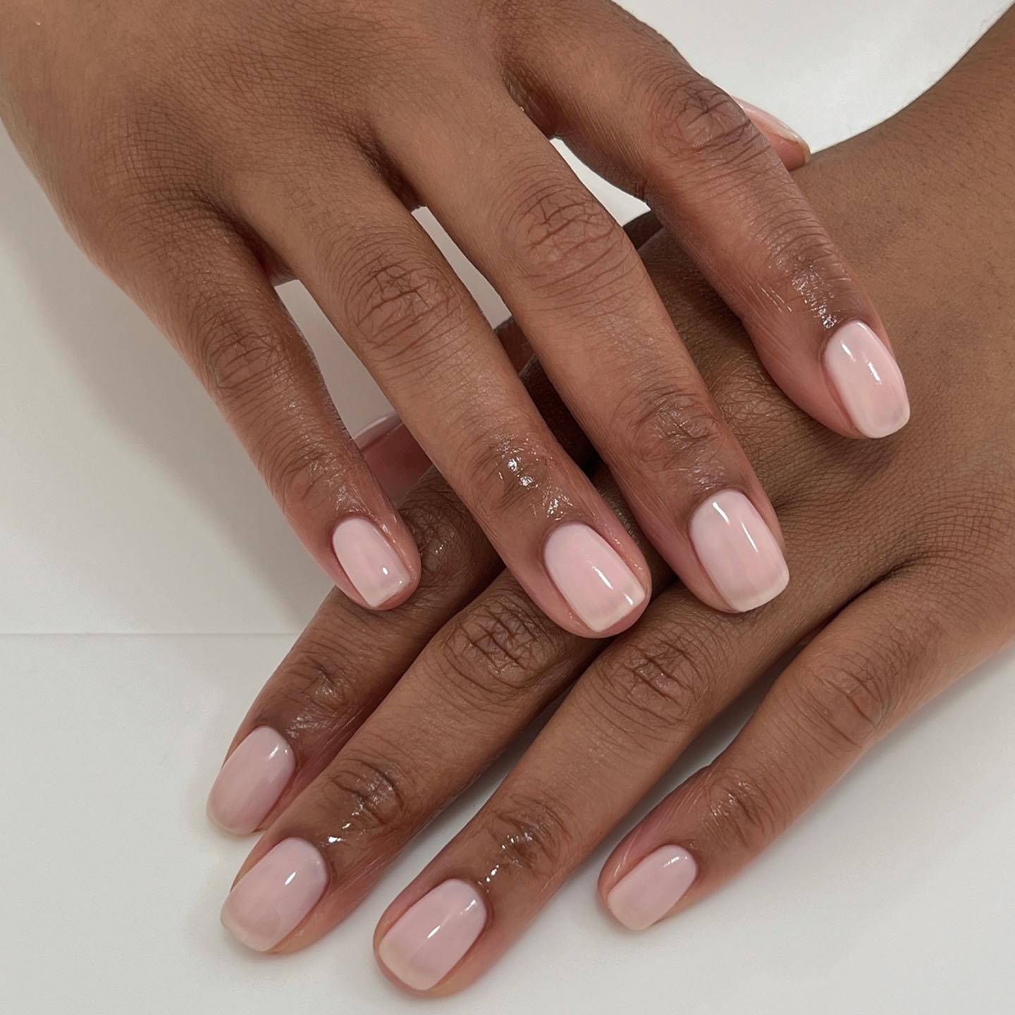 A short, square, milky white manicure