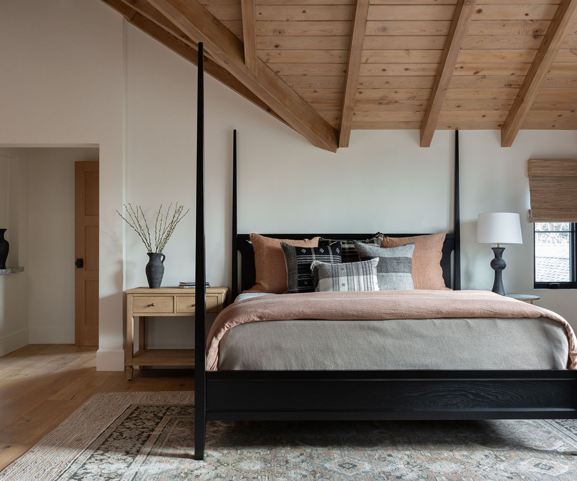 bedroom with four poster and vaulted timber ceiling