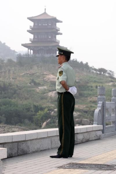 A local military guard keeps watch.