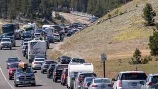 Motorists in RVs, cars and trucks line up to visit the Midway Geyser Basin July 14, 2021 at Yellowstone National Park, Wyoming.