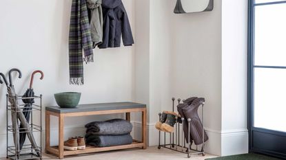 white entryway with bench and storage for boots, umbrellas and coats