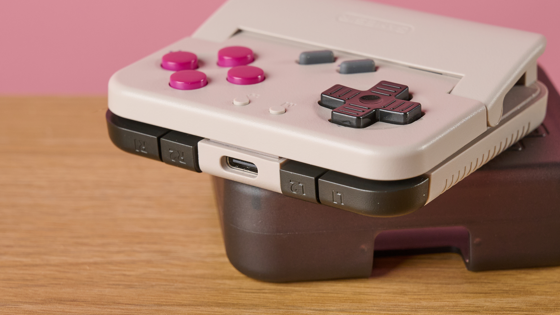 The GameSir Pocket Taco laid flat on top of its carry case, with a particular focus on the USB-C port and the L1, L2, R1 and R2 buttons.