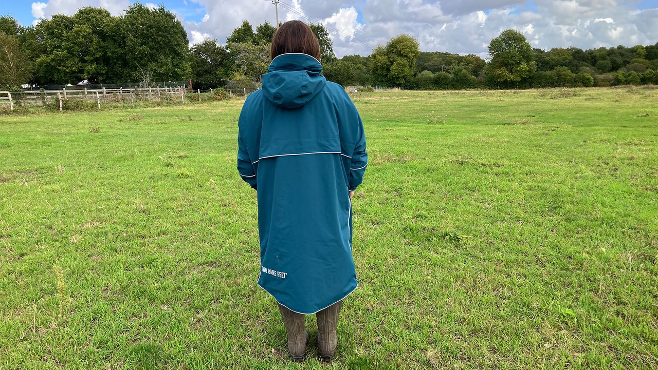 Lady wearing Two Bare Feet Hi-Vis Lightweight Riding Robe back view hood down