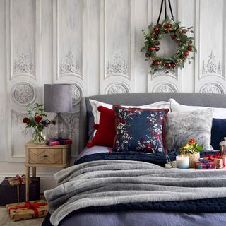 Bed dressed with Christmas bedding and wreath