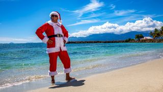 Commissioner Selwyn Patterson (Don Warrington) dressed as Santa on the beach for the Death in Paradise Christmas Special