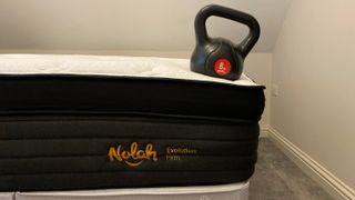 A weight on the edge of the Nolah Evolution 15" mattress