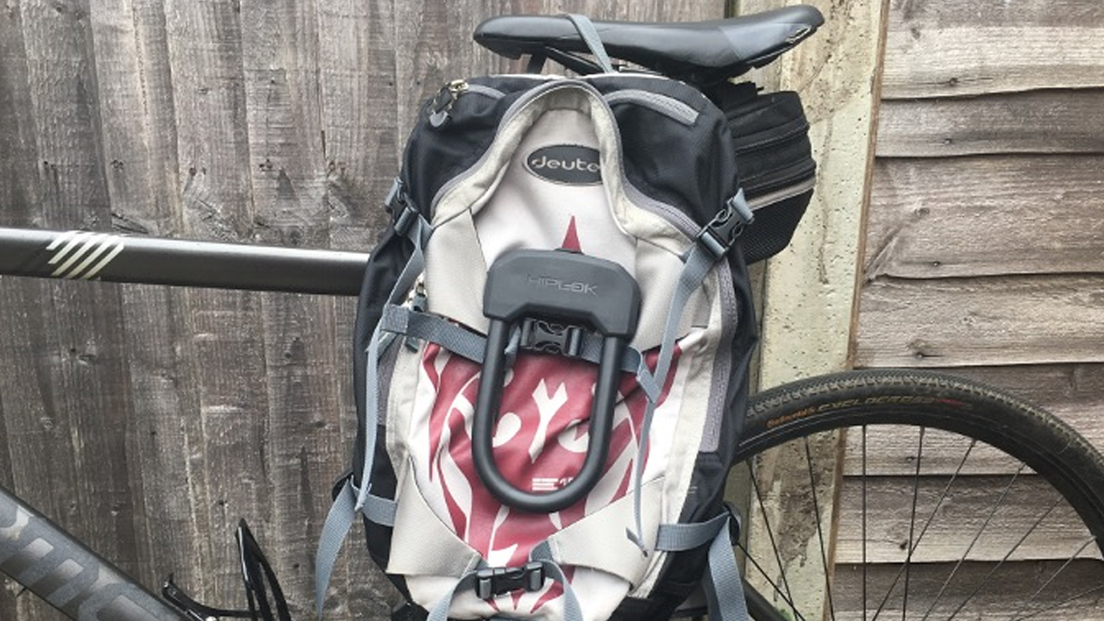 Hiplok D mounted on a rucksack slung over a hybrid bike