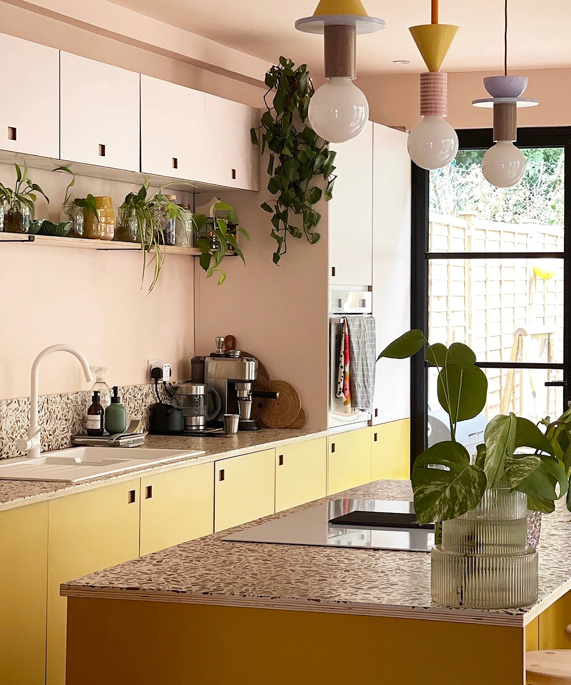 Galley kitchen idea with plywood yellow cupboards