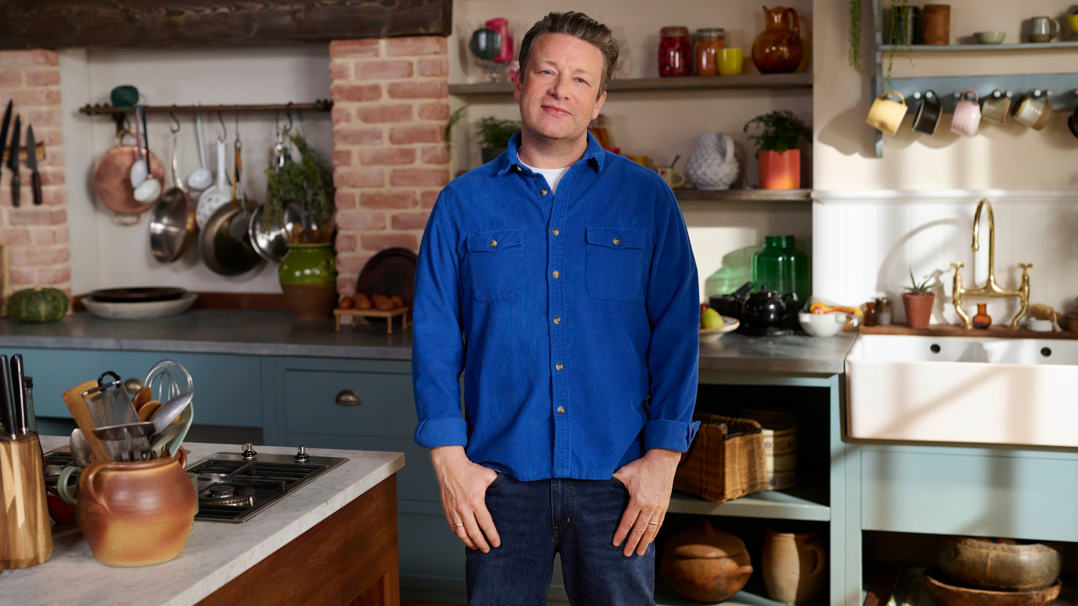 Jamie in a blue shirt standing in a kitchen.