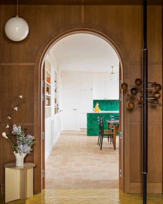 view from an entryway with wooden walls of a bright dining room