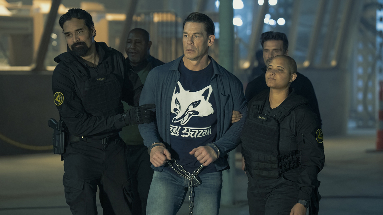 A chained-up Chris Smith walking with ARGUS agents in Peacemaker season 2 episode 8