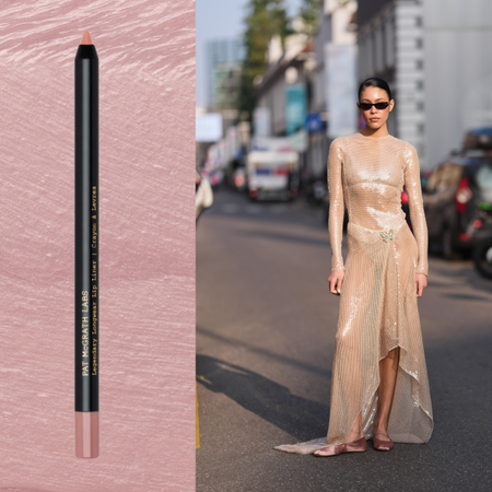 W woman wearing a nude gown next to a lip liner. 