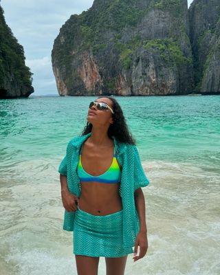 Woman wearing blue swimsuit cover-up set.