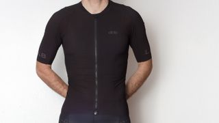 Josh Ross stood in front of a white background wearing a black dhb jersey