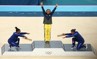 Simone Biles, Rebeca Andrade, and Jordan Chiles celebrate the first ever all-Black gymnastics podium at the Paris Olympic Games in July 2024.