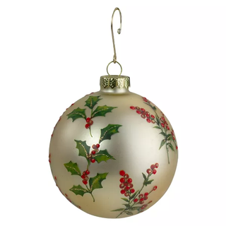 gold ornament covered in holly leaves