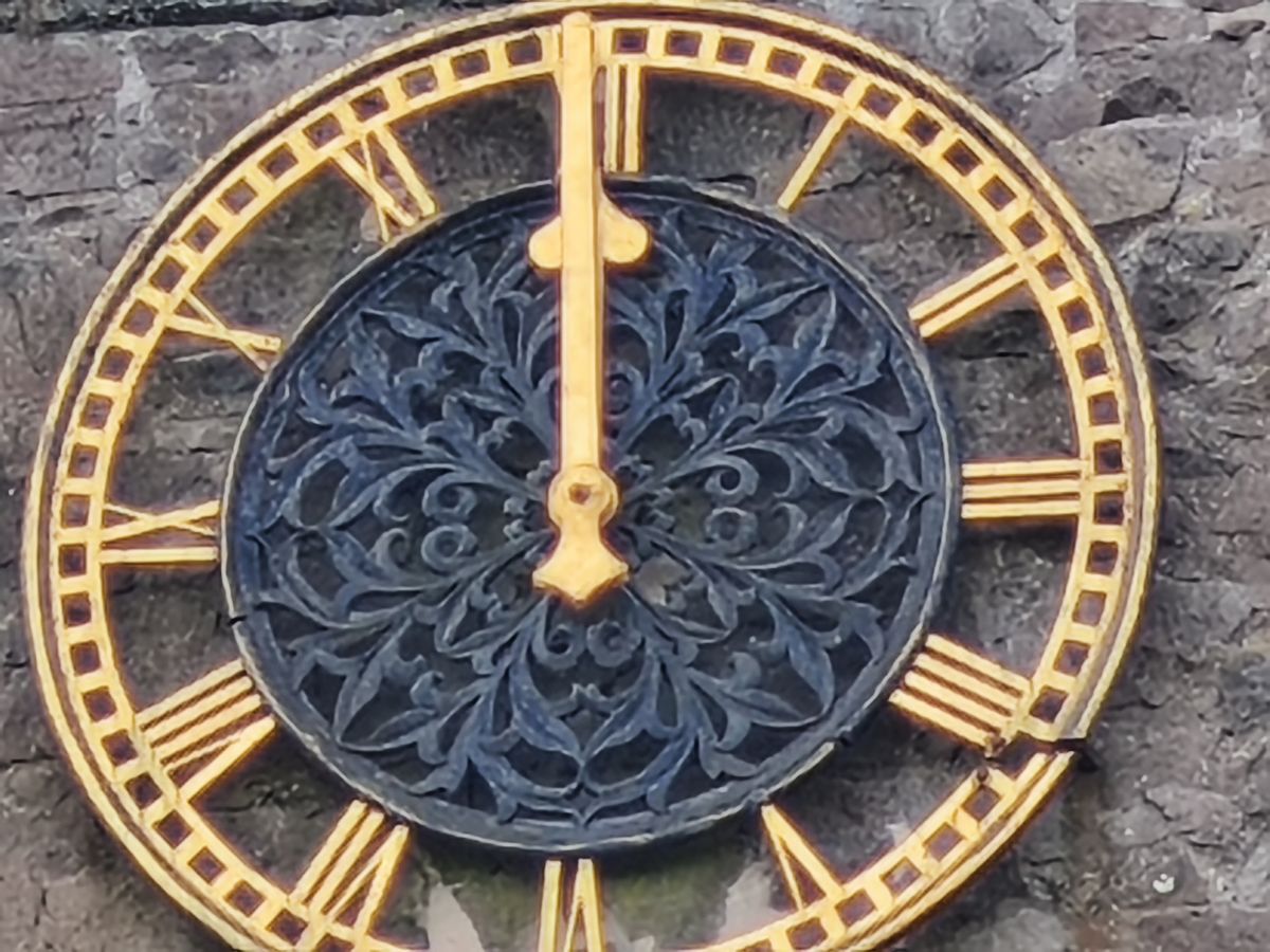 Close up of a clock on a stone church tower