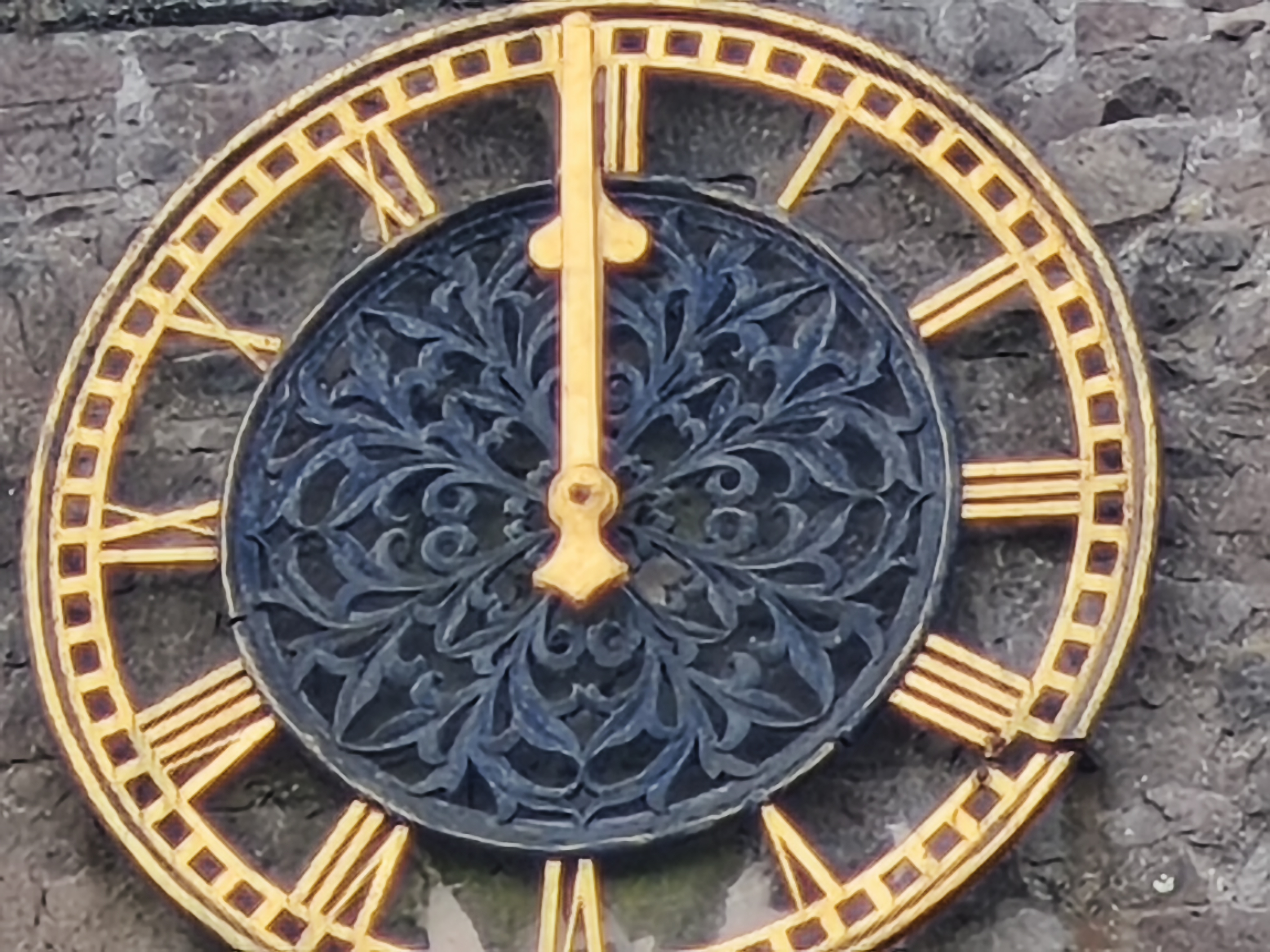 Close up of a clock on a stone church tower