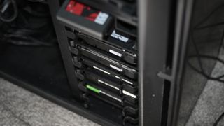 stack of hard drives and SSD in a gaming PC