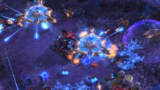 A battle in StarCraft 2 with gunfire and lazers.