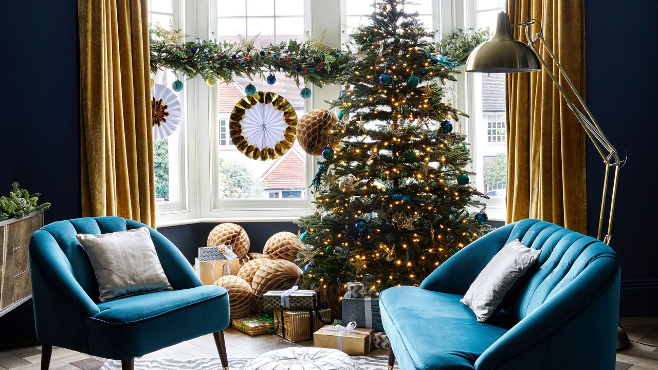 navy living room with gold curtains and christmas tree