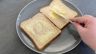 Buttering bread for the air fryer cheese on toast recipe