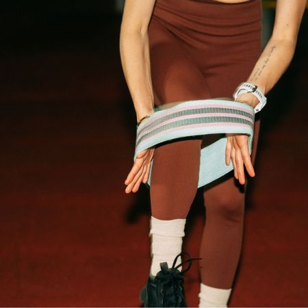 A woman using a resistance band for one of the best resistance band glute workouts for beginners