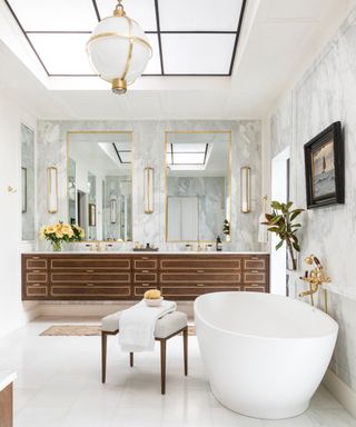 Modern bathroom with large mirrors, sky light and freestanding bath
