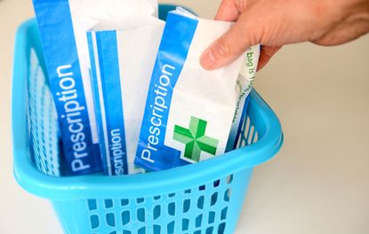 Packaged prescription medication being placed into a basket