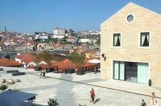 A paved plaza with buildings and blue skies