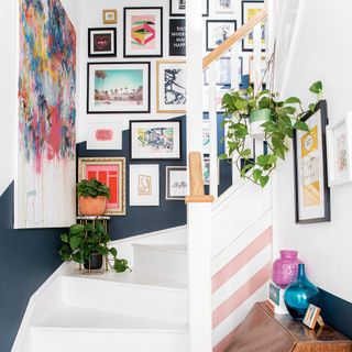 entrance stairs with frames on white wall