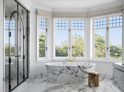 A bathroom with a marble bathtub