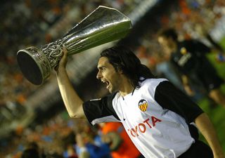Valencia defender Roberto Ayala celebrates with the UEFA Cup trophy in 2004 after the Spanish side's win over Marseille in the final.