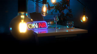 Vibrant podcast studio featuring a neon On Air sign, microphone, and ambient lighting on a desk.