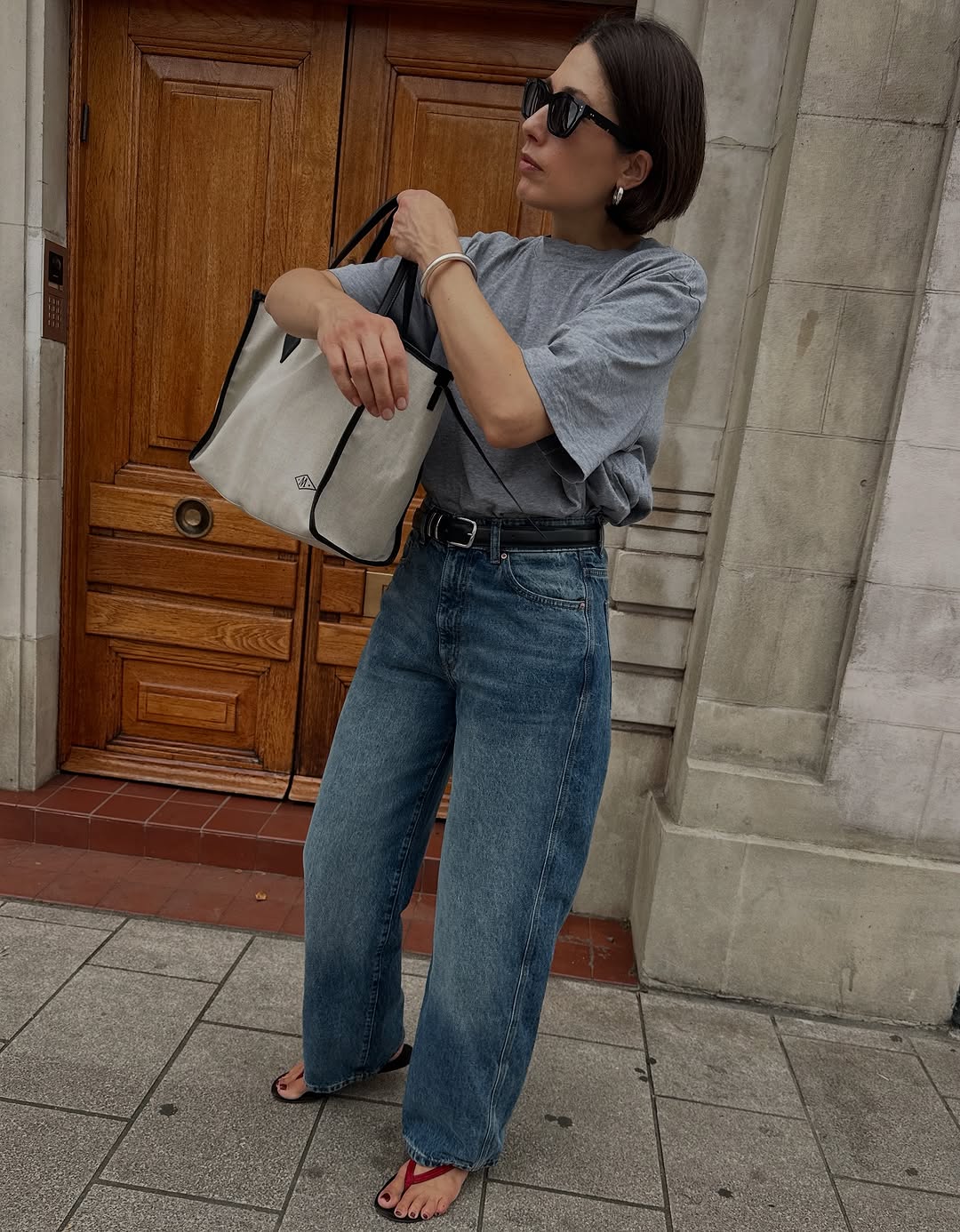 woman wearing dirty denim wash jeans fall denim trend 2025