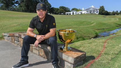 Trevor Immelman poses with the Presidents Cup during the Captains Visit for the 2022 Presidents Cup at Quail Hollow Club