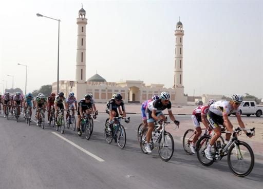 The riders pass a mosque