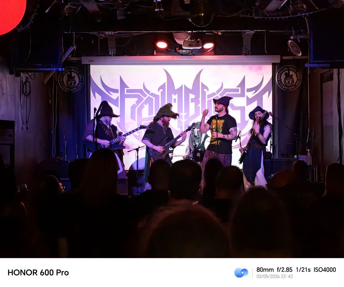 Band performing on stage in front of a crowd at a live music venue