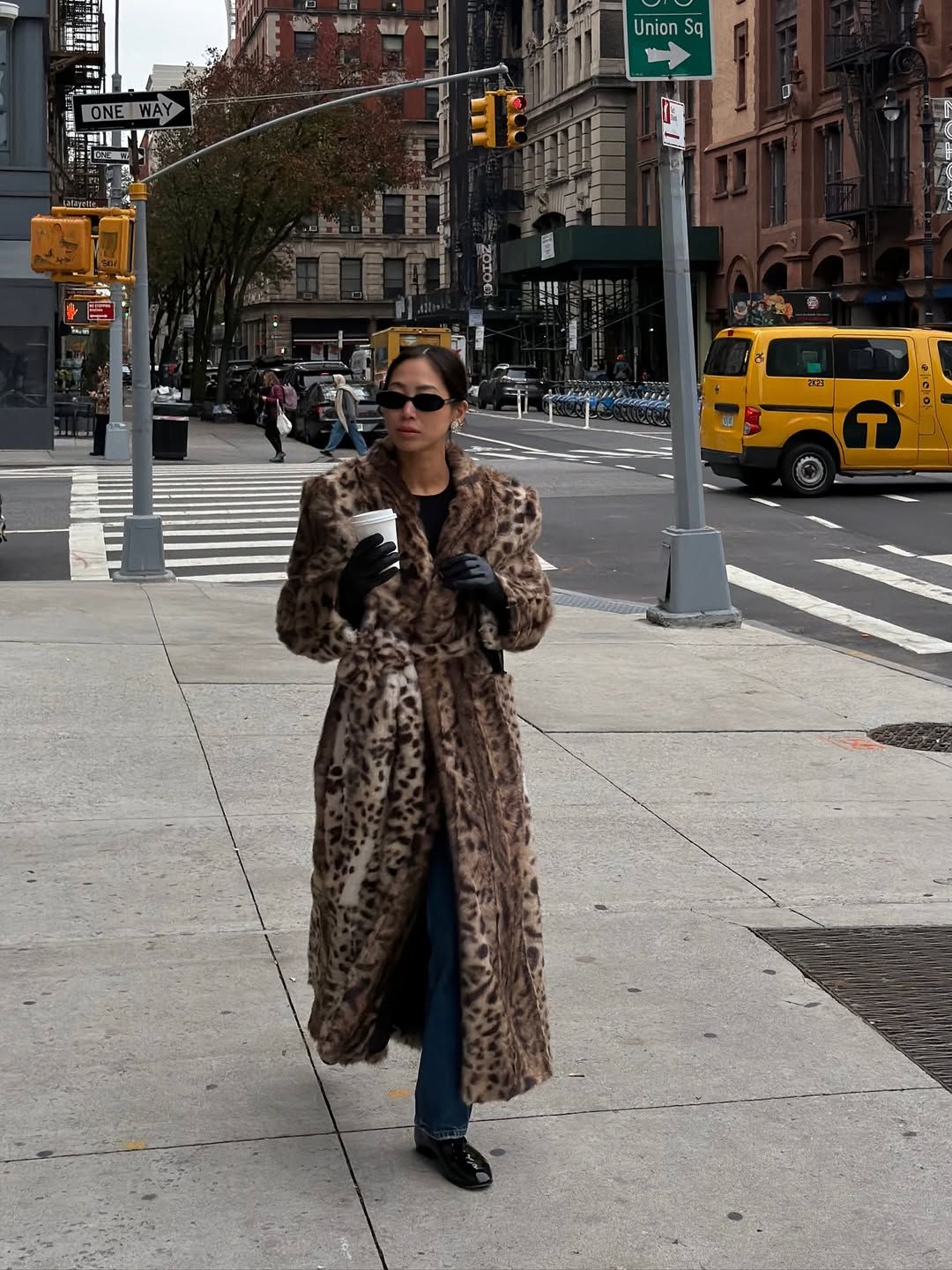 @aimeesong wearing jeans and animal print faux fur coat