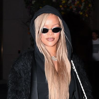 Rihanna wearing an all-black outfit and a white Chanel purse while in New York City May 2024