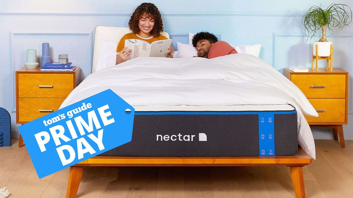 A couple lay on the Nectar memory foam mattress in a blue bedroom. A Prime Day badge is overlaid on top