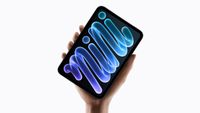 A hand holding an iPad Mini on a white background