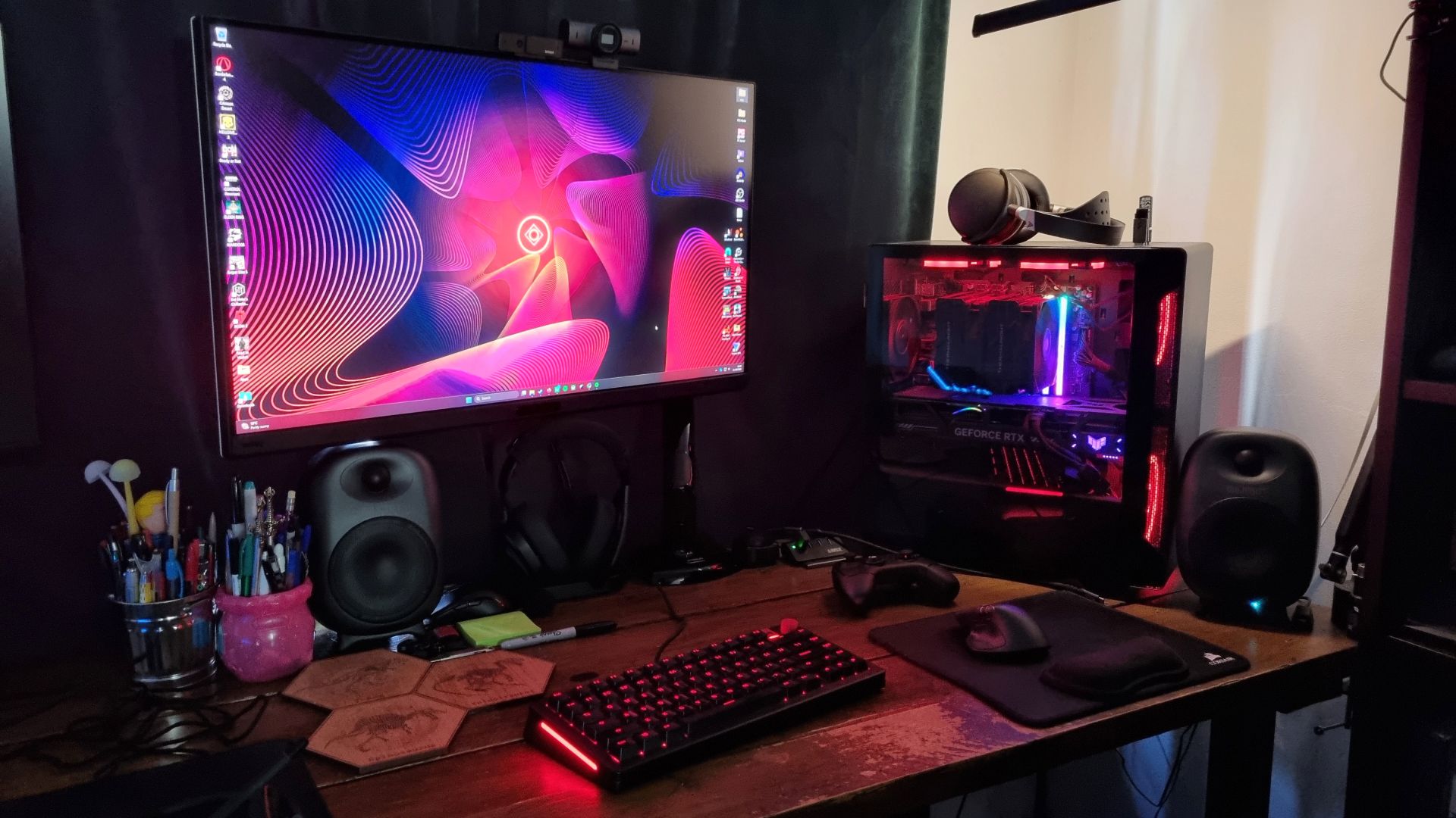 A red-RGB-lit gaming PC and desk setup